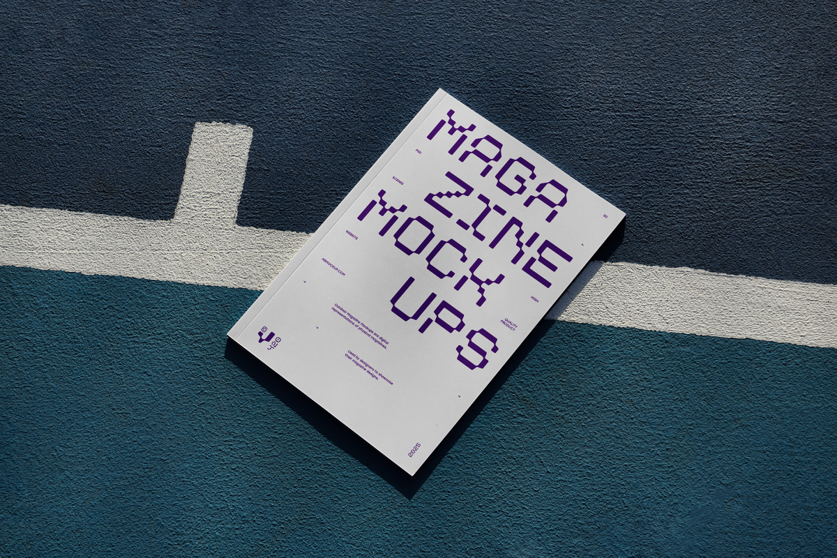 View from above of outdoor magazine mockups with strong purple typography design lying on a basketball court.