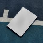 View from above of a white outdoor magazine mockup lying on a basketball court.