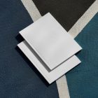 View from above of two white outdoor magazine mockups lying on a basketball court.