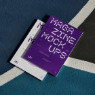 View from above of two outdoor magazine mockups with strong purple typography designs lying on a basketball court.