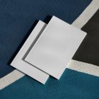 View from above of two white outdoor magazine mockups lying on a basketball court.