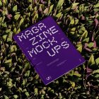 View from above of outdoor magazine mockups with strong purple typography design lying on succulent flowers.