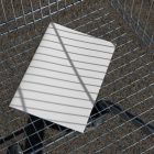 View from above of a white outdoor magazine mockup lying in the shopping cart.