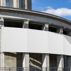 Front view, divided into six parts, White Banner Mockup attached to the concrete poles. Scene from our Museum Mockups product.