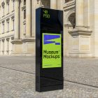 Front view, Monument Poster Mockup with neon green and purple design standing before an old architecture building. Scene from our Museum Mockups product.