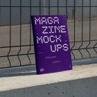 Front view, of outdoor magazine mockups with strong purple typography design resists on metal net fence in black color.