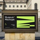 Front view, Horizontal Poster Mockup with white, black, and neon green geometric design in front of the an old building. Scene from our Museum Mockups product.