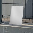Front view, of a white outdoor magazine mockup resists on metal net fence in black color.