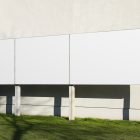 Front view, Three White Rectangle Banner Mockup and metal construction standing in front of the beige building wall. Scene from our Museum Mockups product.