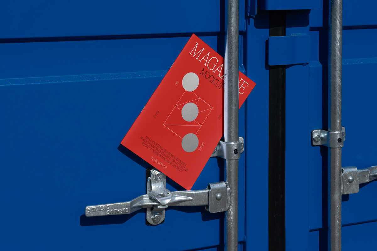 Front view, of outdoor magazine mockups with simple minimalist designs in black and red colors, serif typography, and circle foil patterns lies between a blue container and a silver metal tube.