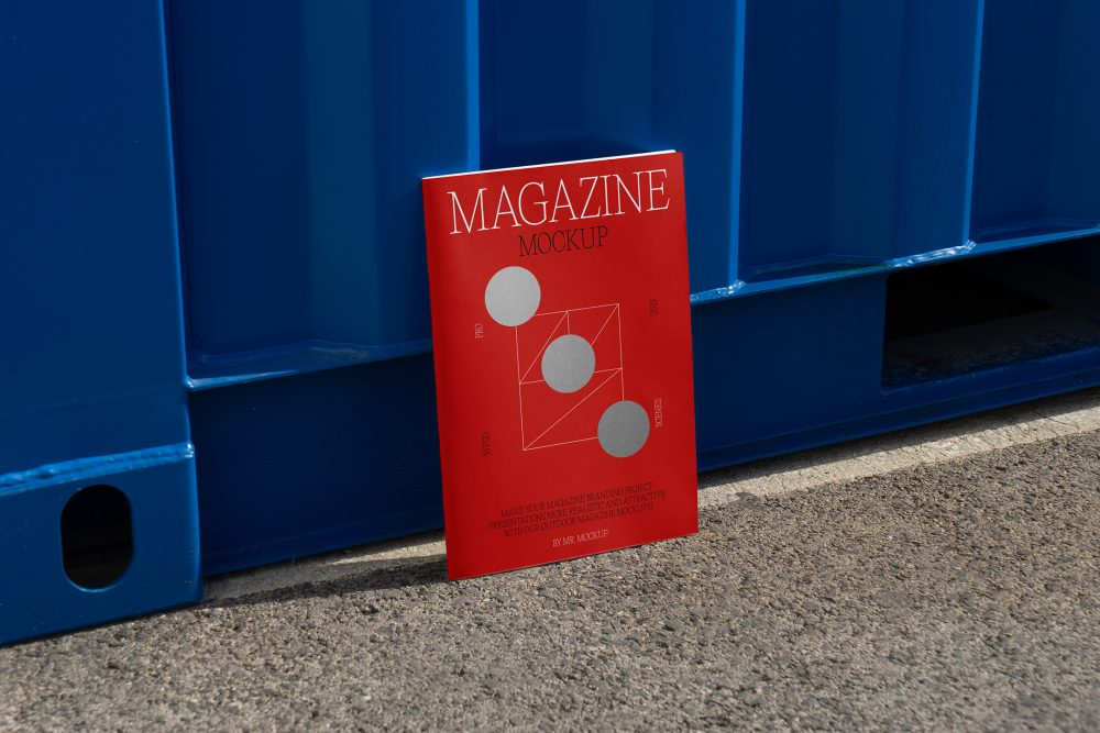 Front view, of outdoor magazine mockups with simple minimalist design in black and red color, serif typography, and circle foil pattern resist on the blue container color.