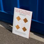 Front view, of outdoor magazine mockups with simple minimalist design in black and red color, serif typography, and diamond foil pattern resist on the blue container color.