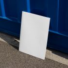 Front view, of a white outdoor magazine mockup resist on the blue container color.