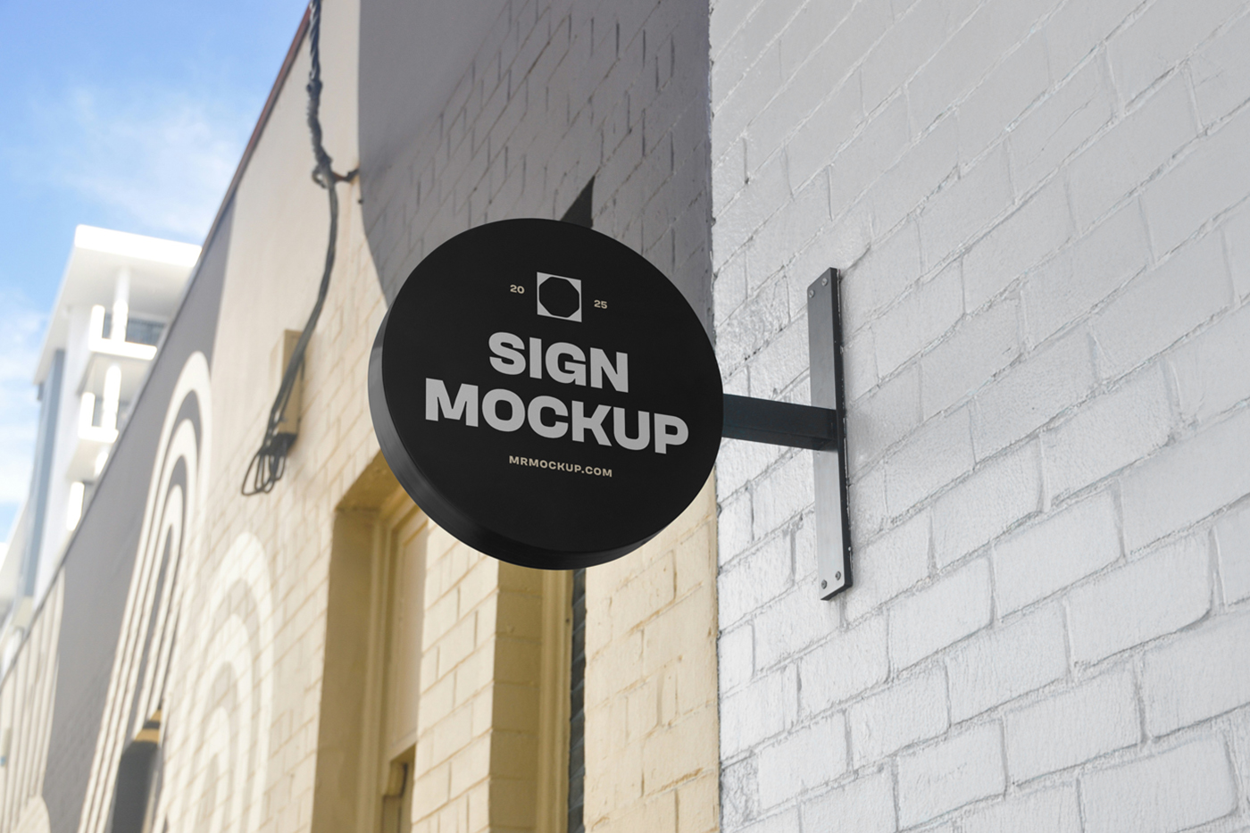 Front view, Circle Signage Attached to Wall Mockup in black color and white, strong design against the brick building.