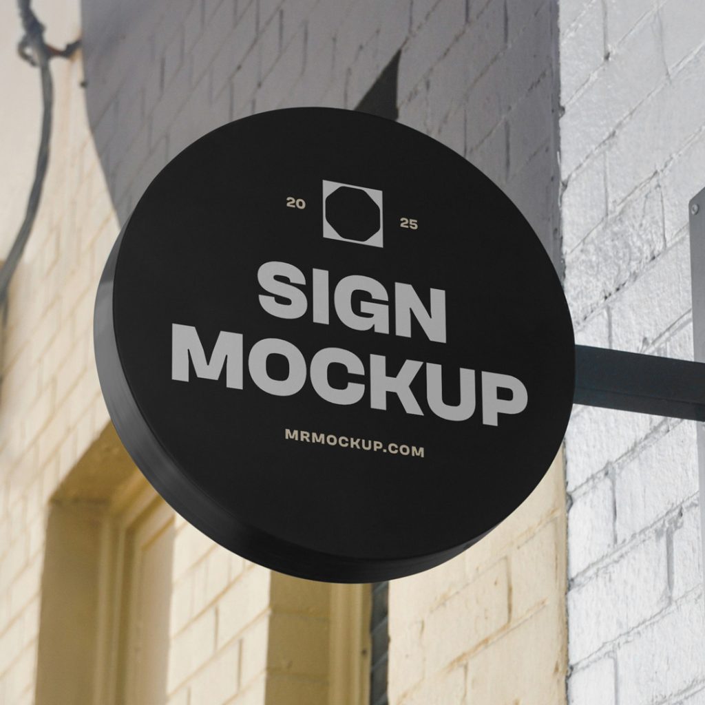 Front view, Circle Signage Attached to Wall Mockup in black color and white, strong design against the brick building.
