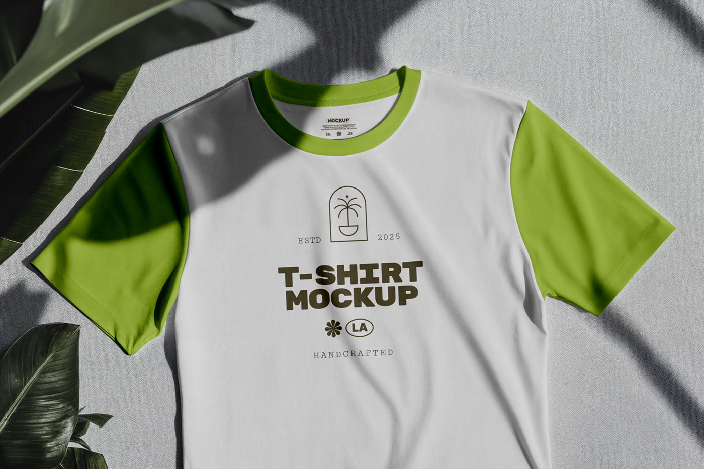 Laying T-Shirt Mockup with a dark green color logo on the gray color floor.