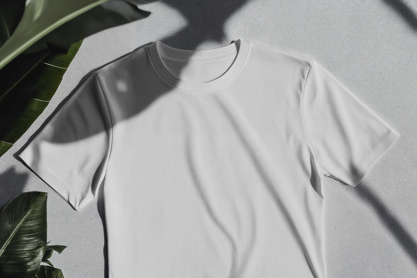 Laying a White T-Shirt Mockup on the gray color floor.