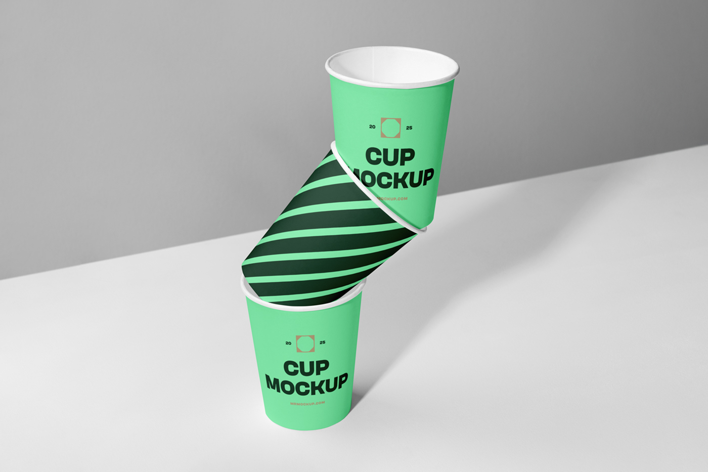 Front view, Three Coffee Cup Mockups with strong geometric typography logo in dark green color standing on the bright gray background.