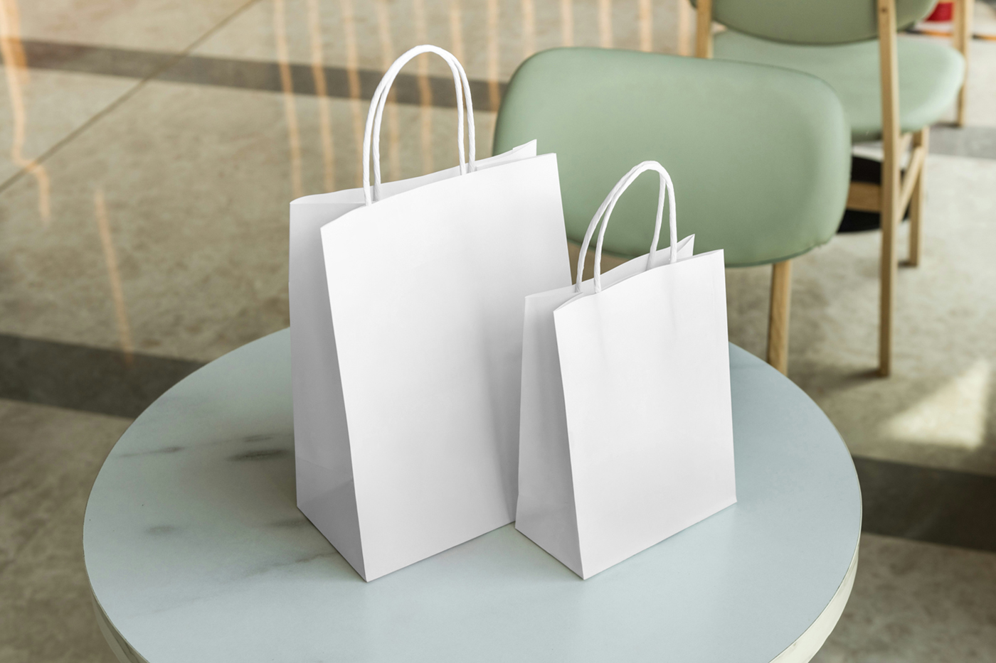 Front view, Two White Paper Shopping Bag Mockups standing on the restaurant marble table.