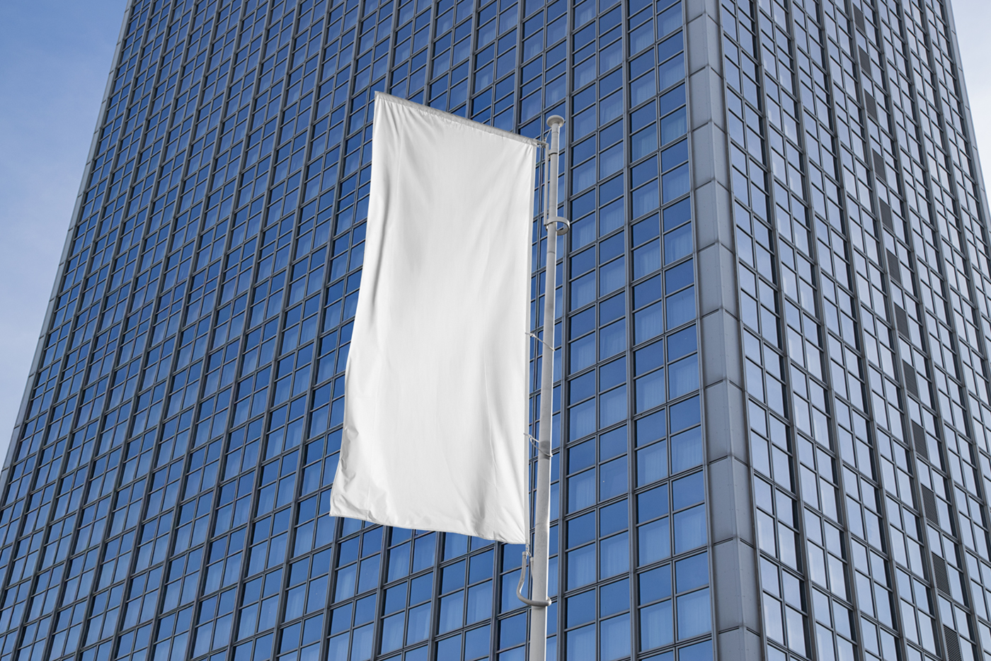 Front view, single a White Waving Flag Mockup against big-city building.