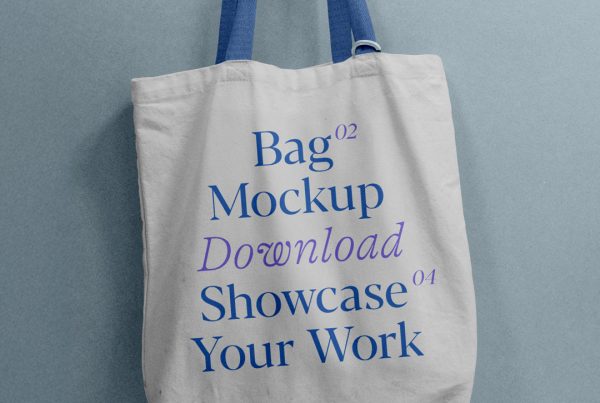 Front view, tote bag mockup with blue and purple typography design hanging on a hook attached to the blue color wall.
