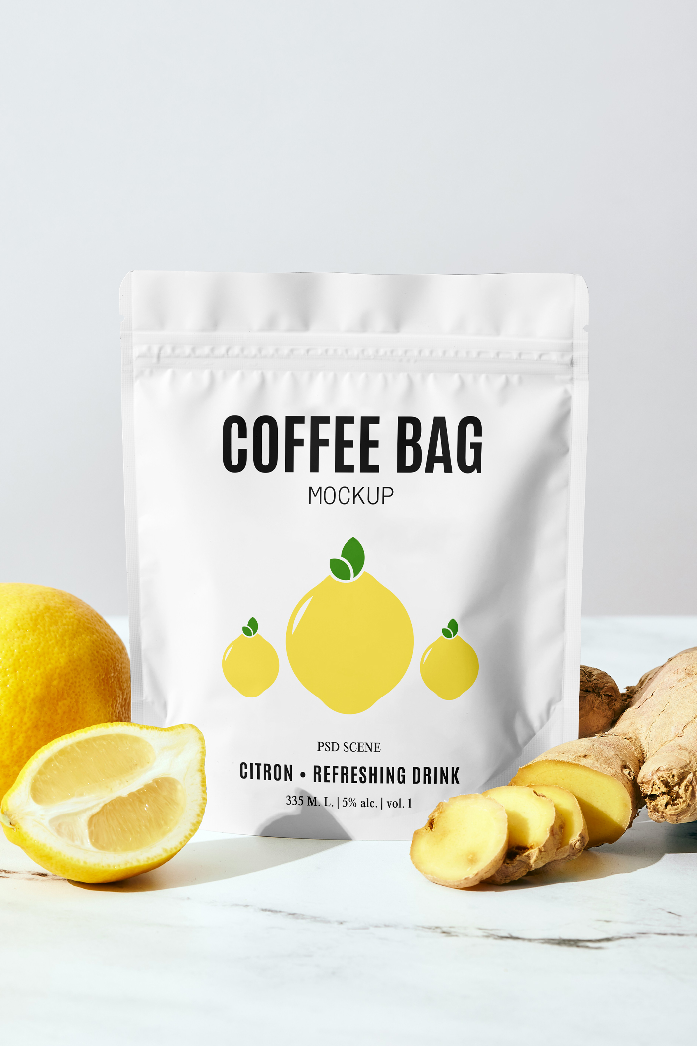 Front view, small coffee bag mockup with bold black typography and simple lemon illustration standing on the table between the lemon and ginger.