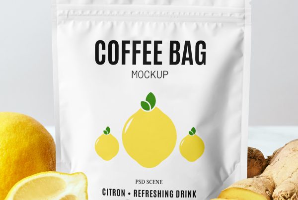 Front view, small coffee bag mockup with bold black typography and simple lemon illustration standing on the table between the lemon and ginger.