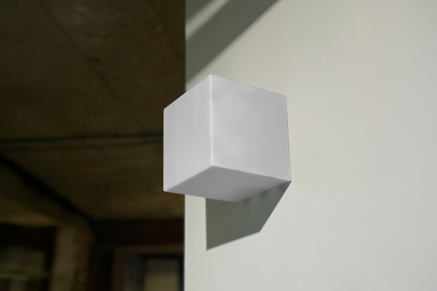 Front view, a white square sign mockup attached to the white wall with reflection viewed.