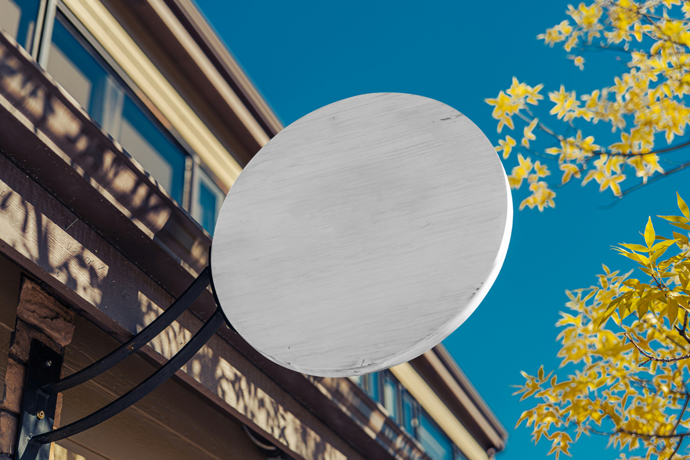 Front view, a white wooden sign mockup attached to the building elevation.