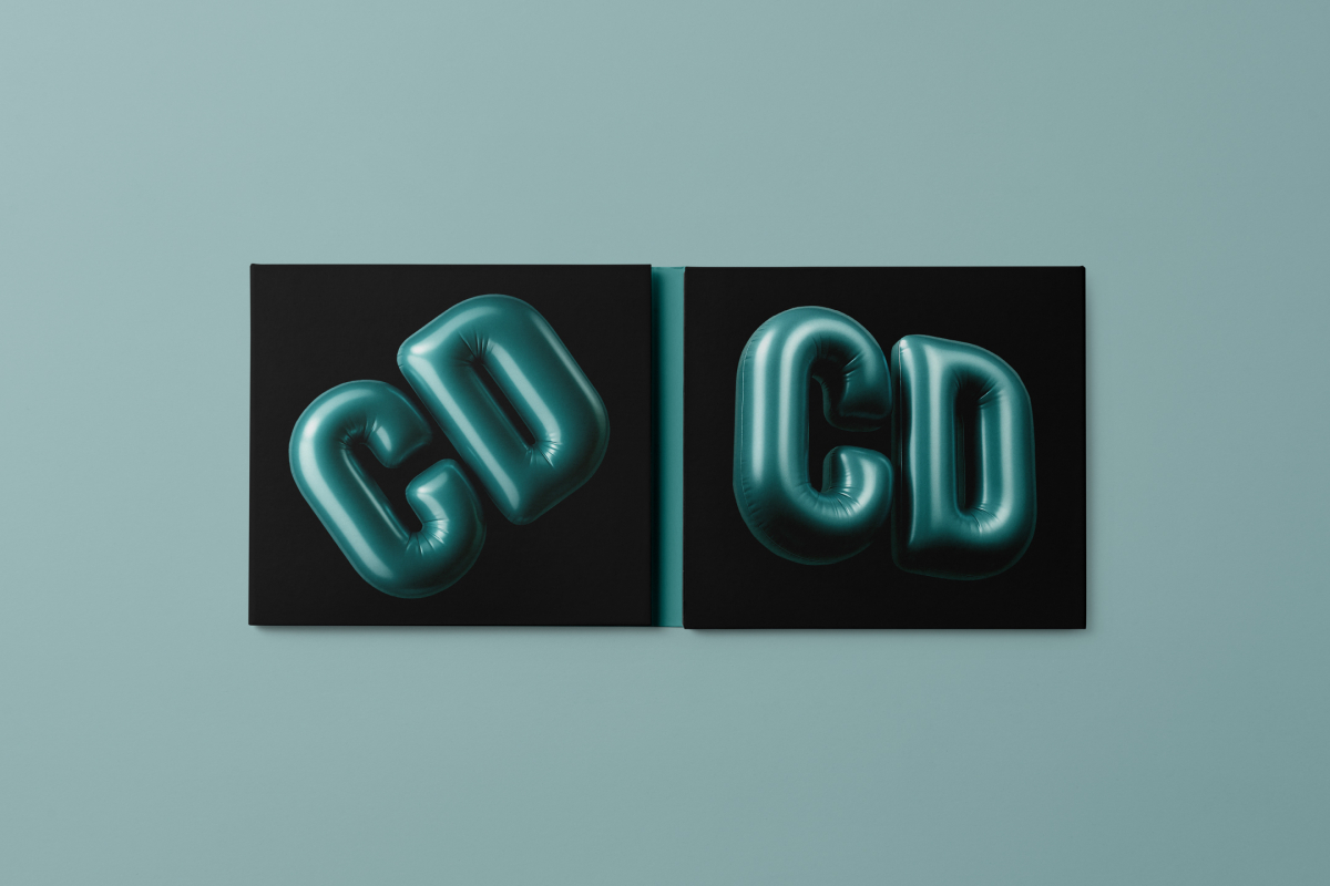 Viewed from above, CD Digipack Mockups presents a green and black disc package with 3D graphics lying on the green background.