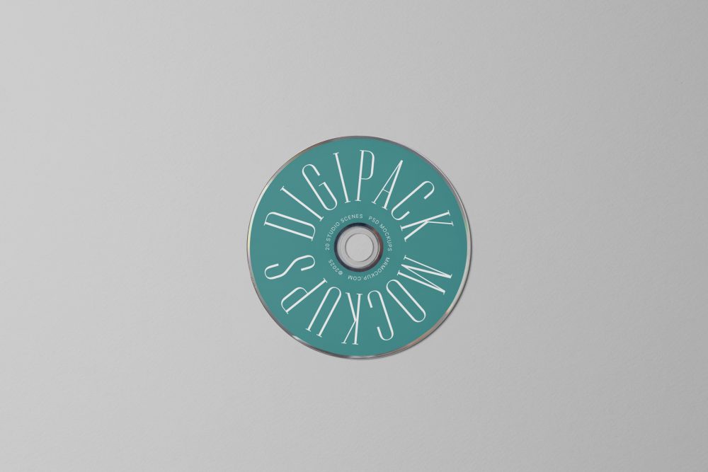 Viewed from above, CD Digipack Mockups presents a green disc with nice white serif typography lying on the gray background.