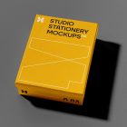 View from above, a yellow box mockup with strong black geometric typography design and white stroke lines. Everything is lying on a dark gray background.