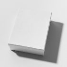 View from above, a white box mockup lying on a white background.