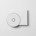 Viewed from above, CD Digipack Mockups presents white disc packaging lying on the white background.