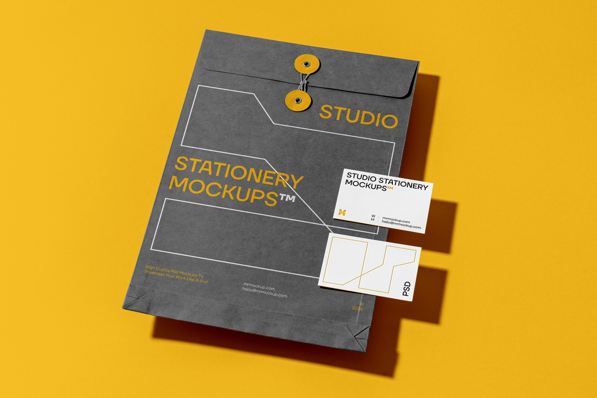 Front view, stationery mockups. Close dark gray envelope mockup with yellow typography and white stroke lines with two white business card mockups lying on it, with a strong black geometric typography design. Everything is lying on a yellow background.