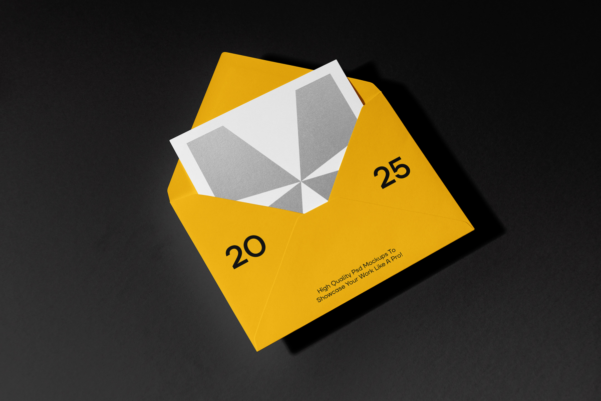 Front view, stationery mockups. An open yellow envelope mockup with black typography protruding from a white square card mockup with a geometric sign. Lying on a black background.