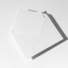 Front view, stationery mockups. An open white envelope mockup and a white square card mockup. Lying on a white background.
