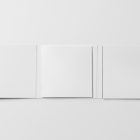 Viewed from above, CD Digipack Mockups presents open white disc packaging lying on the white background.