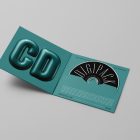 Viewed from above, CD Digipack Mockups presents green disc packaging and a black ejected disc with nice black serif typography and 3D graphics lying on the gray background.