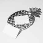 Front view, two white business card mockups lying on the white background or on a silver pineapple shaped metal plate.