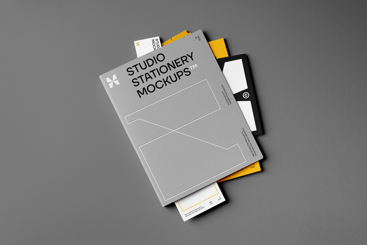Front view, stationery mockups. A grey folder mockup with a protruding white leaflet mockup, a yellow A4 mockup, and a white business card mockup. Everything is lying on a dark grey background.