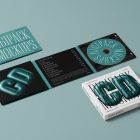 View from above, composition of CD Digipack Mockups presents what is inside the package in green, white, and black colors with nice serif typography and 3D graphics lying on the green background.