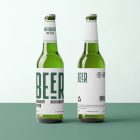 Front view, two beer bottle mockups with white labels and black and dark green designs standing on the green floor.