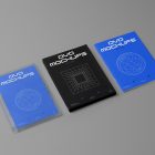 Viewed from above, DVD Mockups presents a transparent plastic package, a black paper box, and a blue booklet with white typography and linear graphics lying on the gray background.