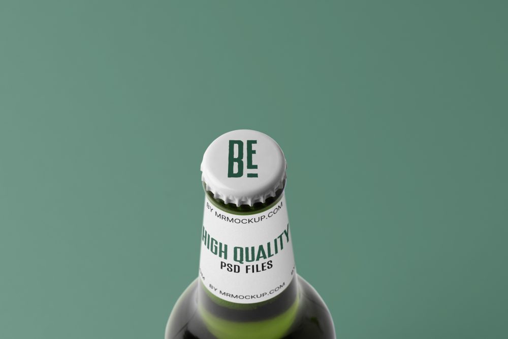 View from above, white beer crown mockup with dark green design, white label with black and dark green typography design against the green background.
