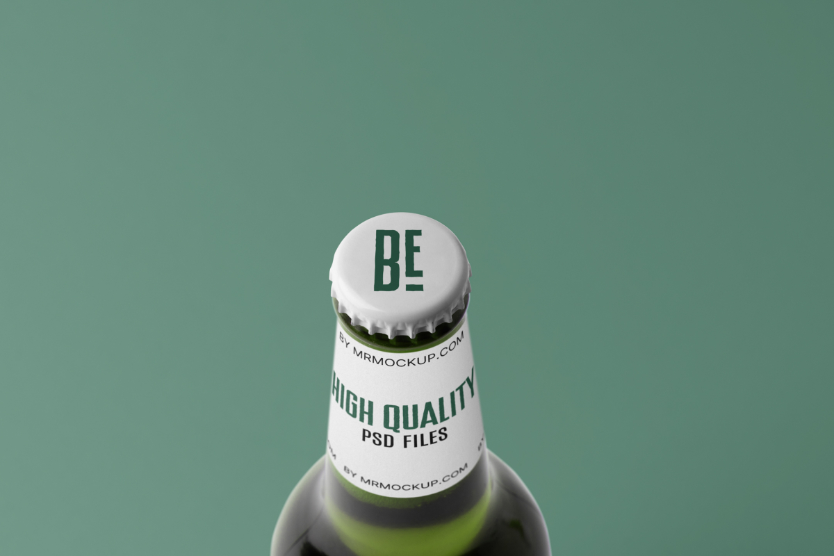 View from above, white beer crown mockup with dark green design, white label with black and dark green typography design against the green background.