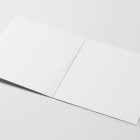 Viewed from above, Vinyl Mockups presents a white open music album cover lying on a white background.