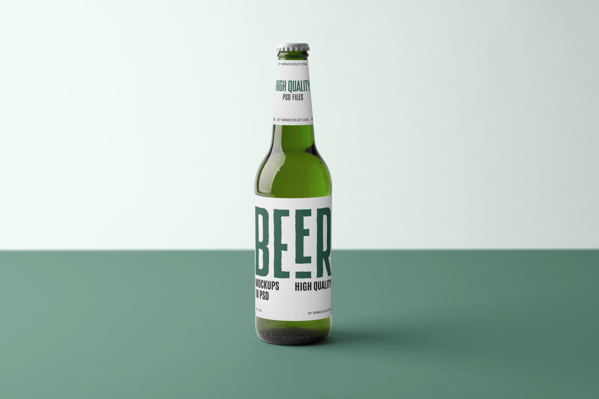 Front view, beer bottle mockups with white label and black and dark green design standing on the green floor.