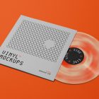 Viewed from above, Vinyl Mockups presents a square music album cover in a gray color with a metal fence graphic and an ejected vinyl disc with pressed graphics in two colors lying on an orange background.