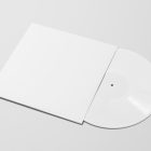 Viewed from above, Vinyl Mockups presents a white square music album cover and a white ejected vinyl disc lying on a white background.